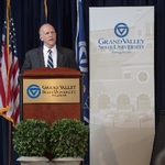 Doctor Potteiger speaking at a GVSU podium